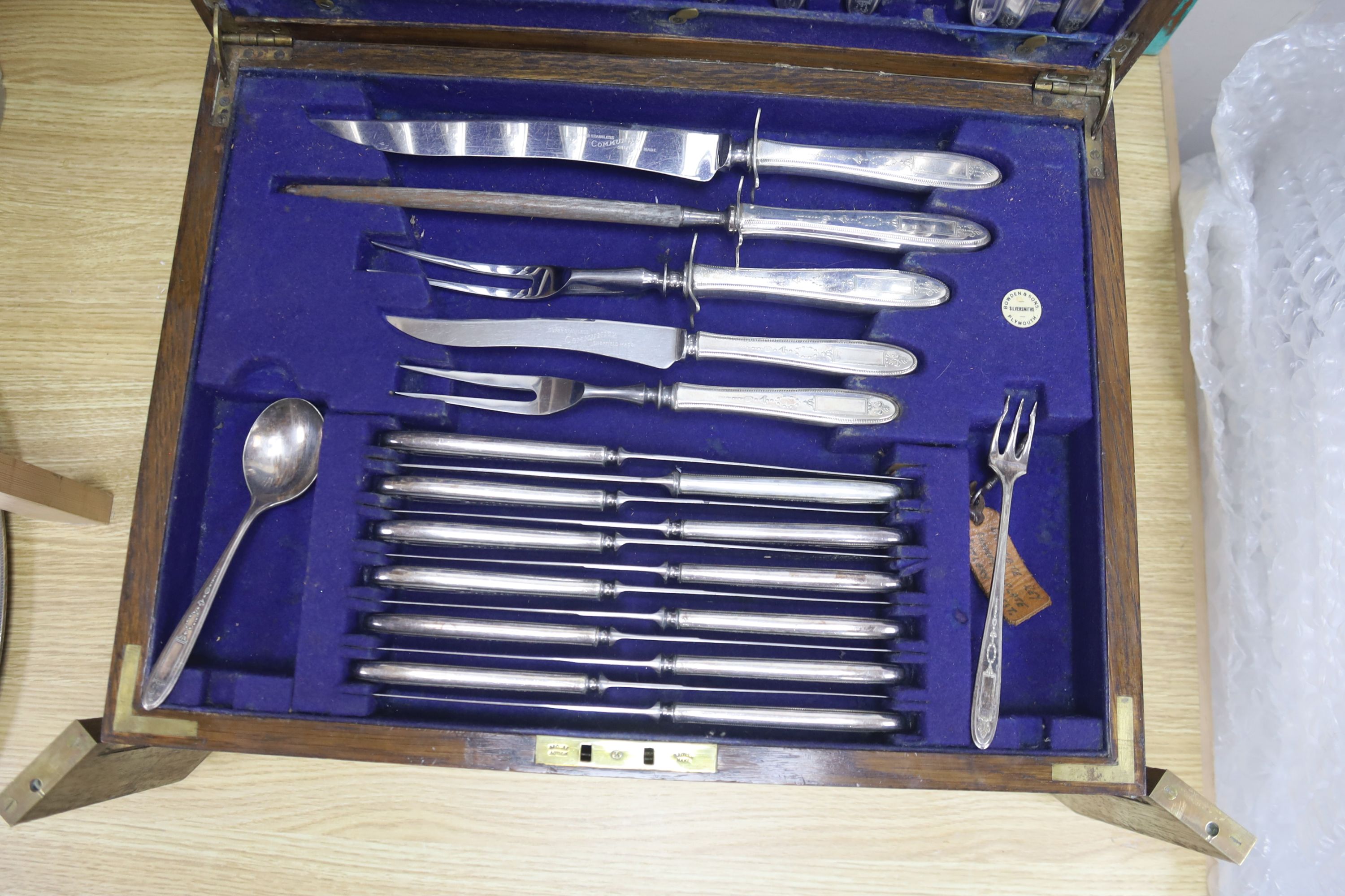 A large early 20th century oak cutlery canteen containing a large quantity of stainless steel cutlery, width 45cm depth 35cm height 23c